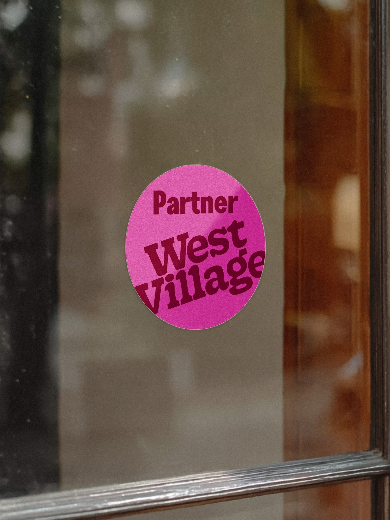 West Village brand identity partner sticker on storefront window