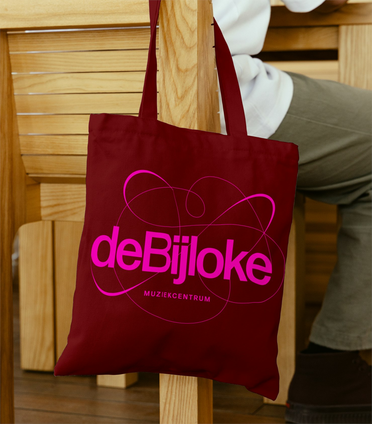 Maroon De Bijloke tote bag with pink wordmark