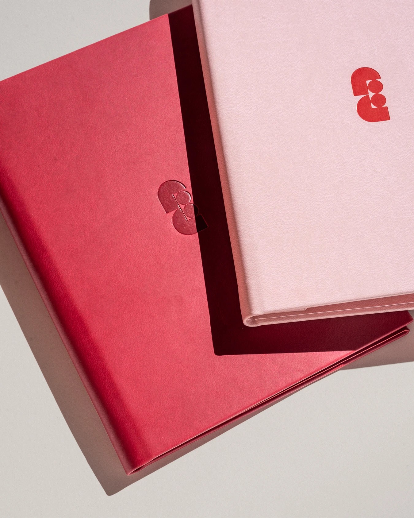 Faubourg Galant branding debossed pink and crimson leather guest notebooks