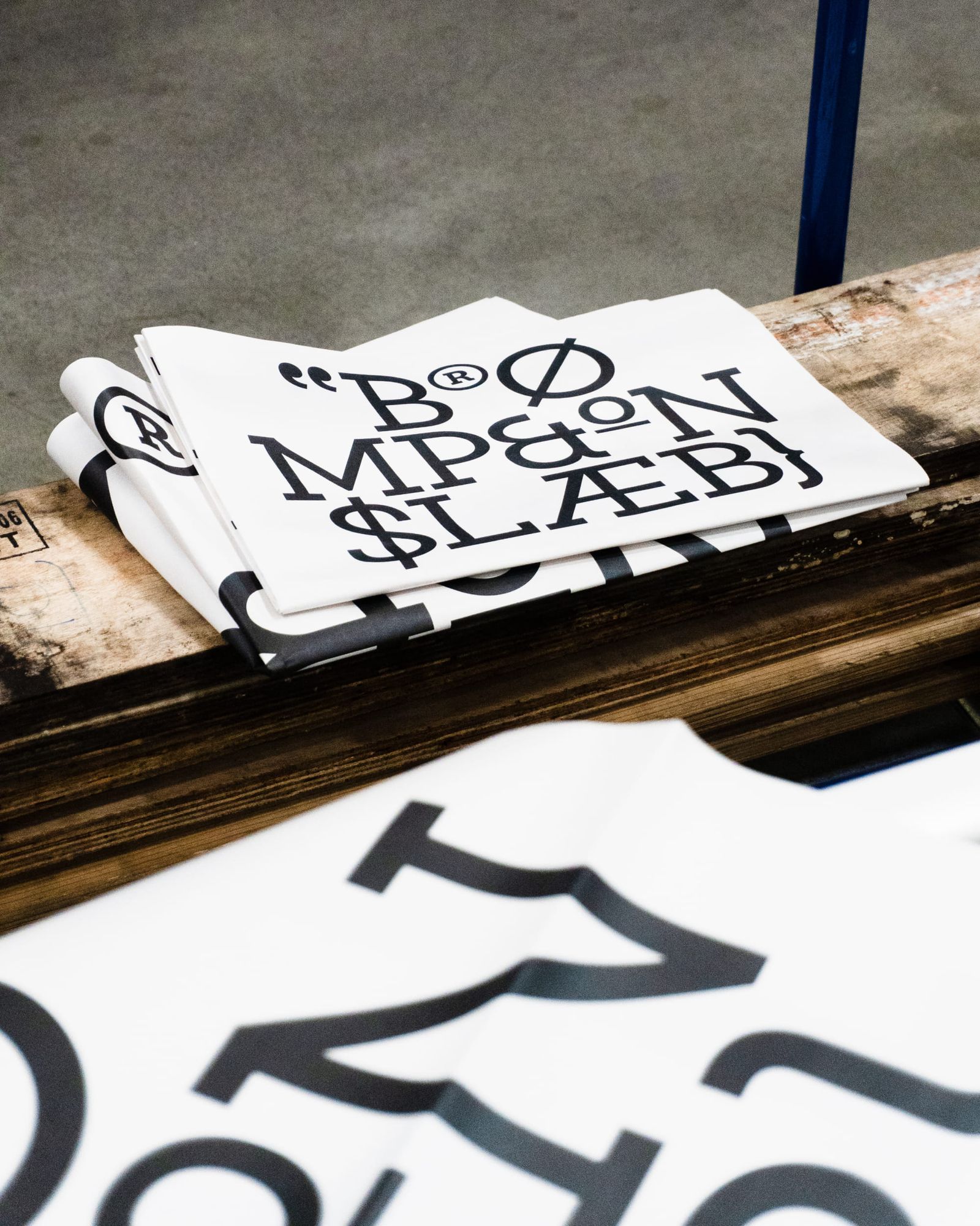 Brompton global branding folded typography newspapers on wooden palette