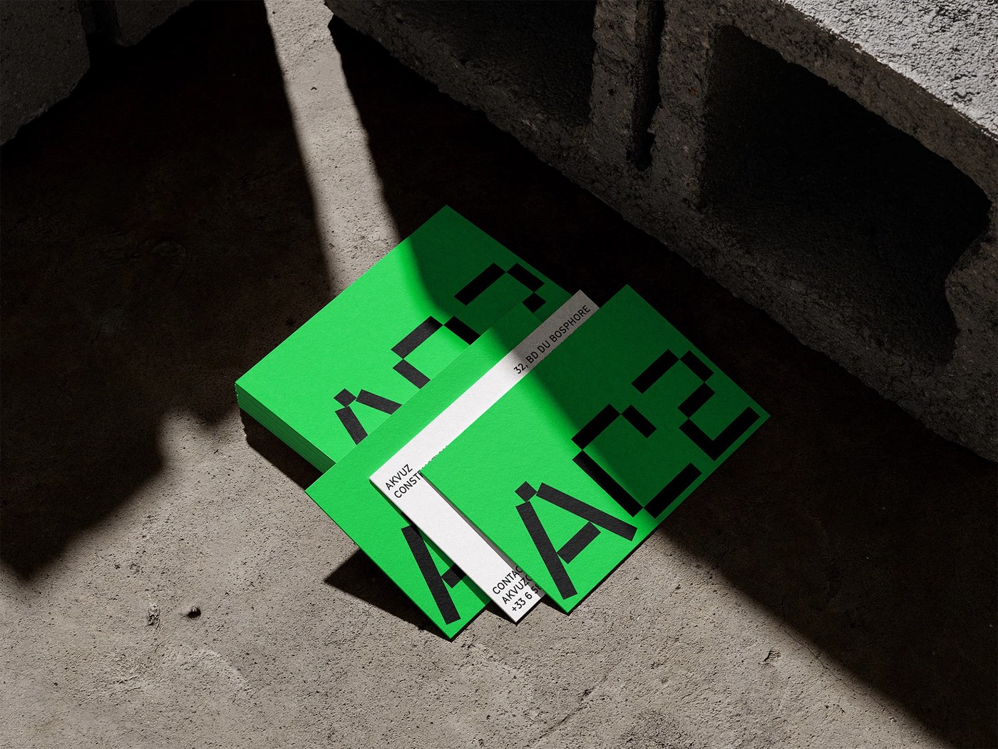 AC2 brand identity design electric green stationery on concrete by Studio Format