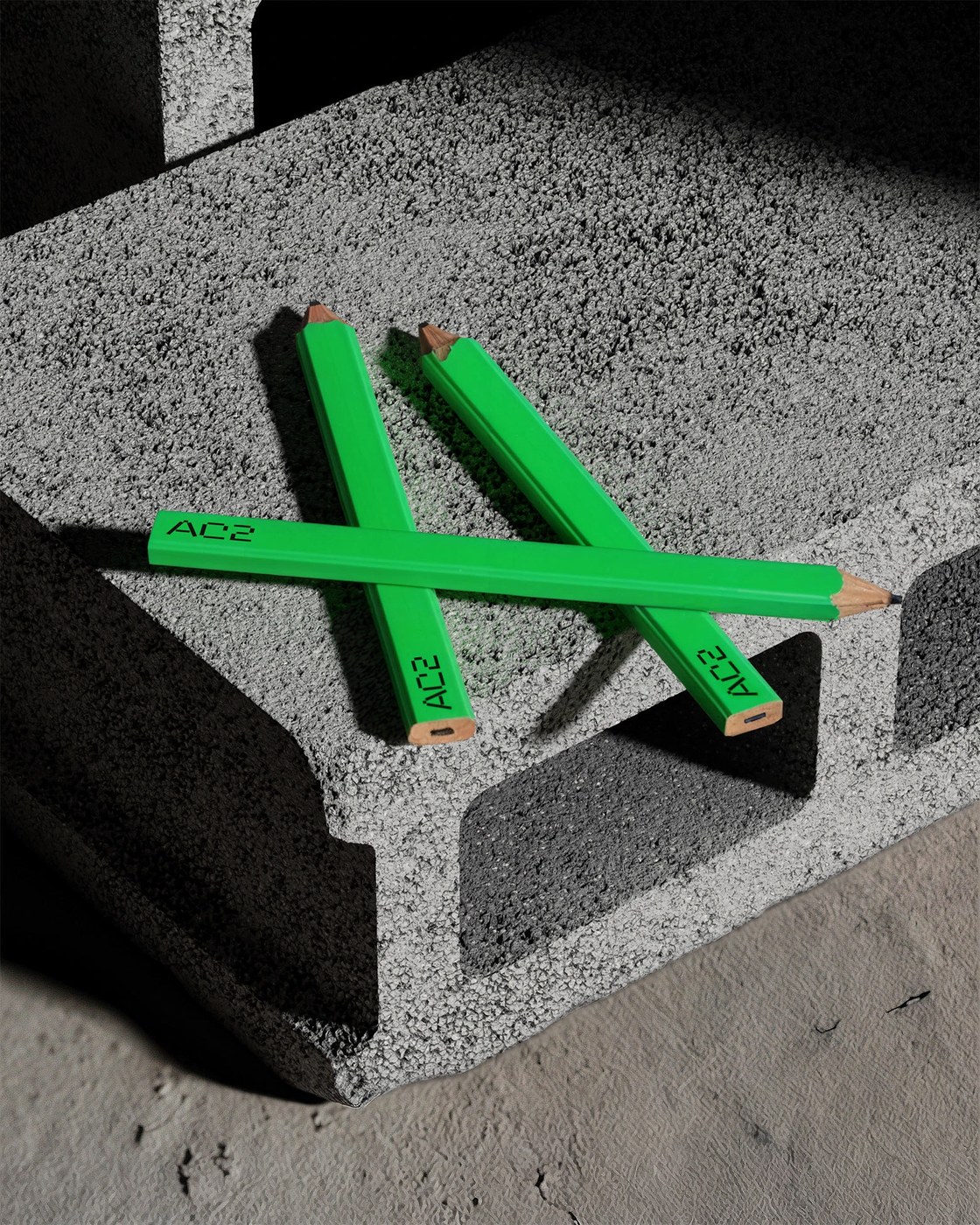 AC2 brand identity design green carpenter pencils forming letter A on concrete
