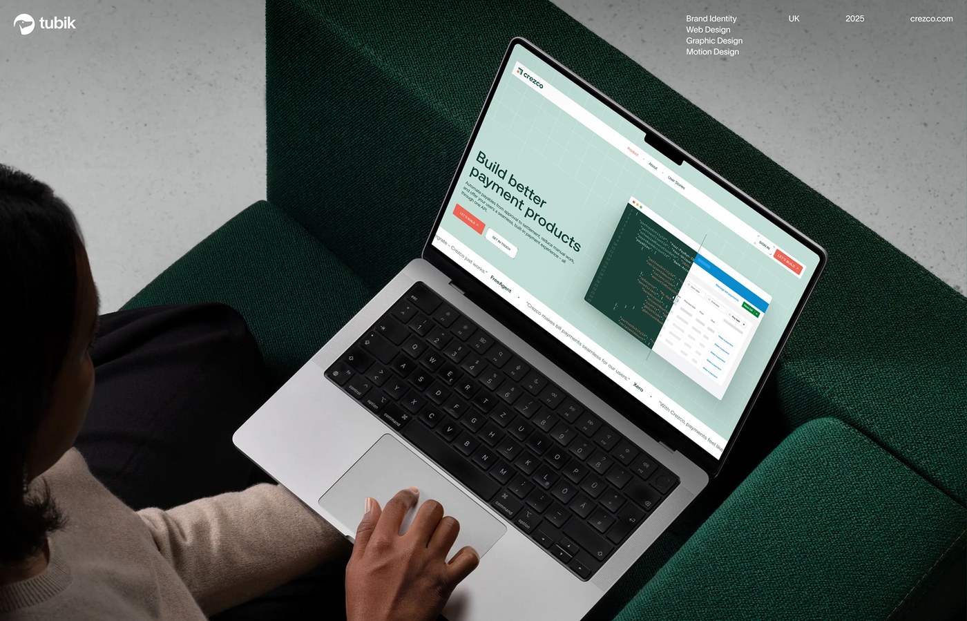 Crezco ui/ux design desktop landing page on laptop featuring payment API code editor and dashboard by tubik studio