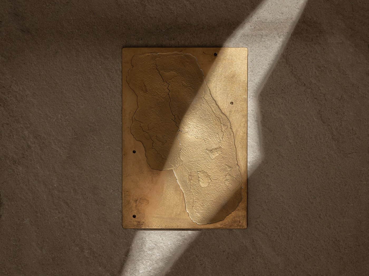 Cast brass and gold relief plate depicting geological diamond terrain on limestone — branding by Two Times Elliott