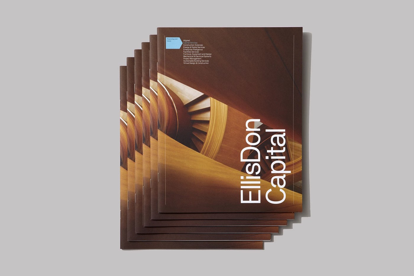 Stacked printed EllisDon Capital brochures — branding design by Underline Studio