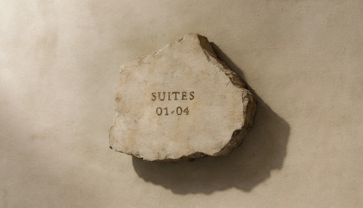 hotel rigen fugitiva .co branding engraved stone sign detailing suite numbers