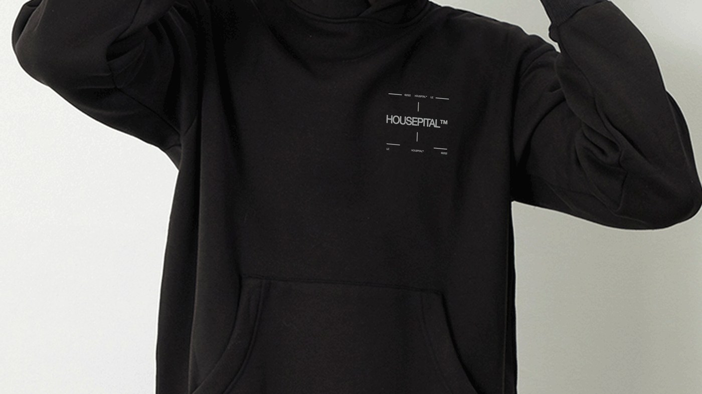 Close-up of black merchandise hoodie showing surgical coordinate crosshairs and branding wordmark