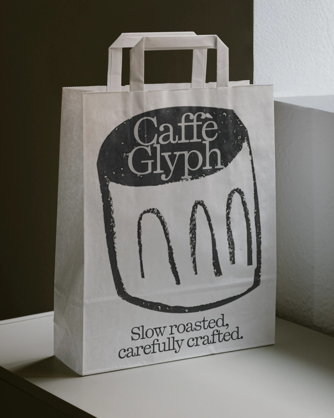Caffè Glyph paper packaging bag featuring PP Kyoto typeface design