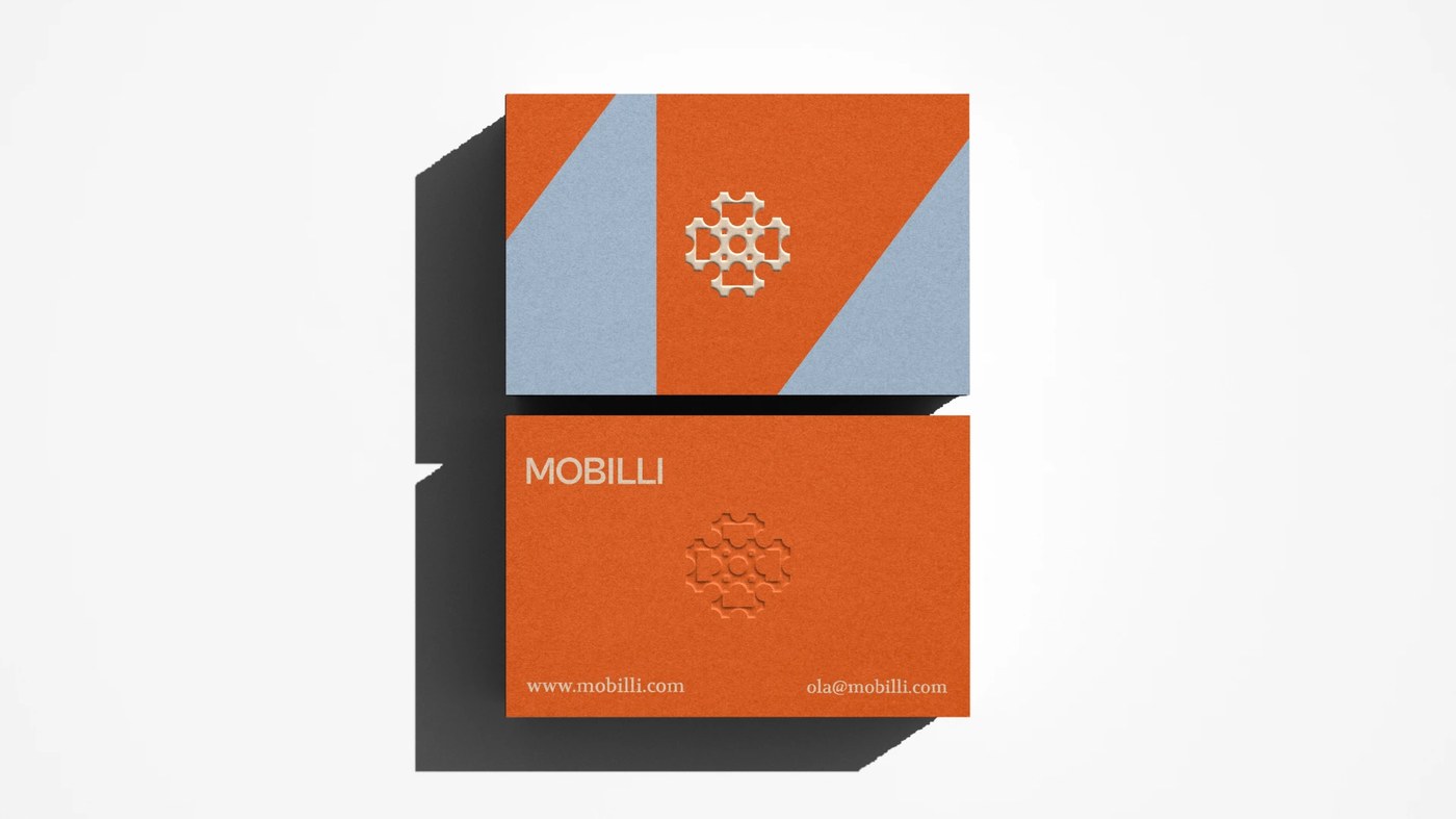 Mobilli business card stationery flat lay with embossed logo mark and tactile paper texture — brand identity by Mariane Farias