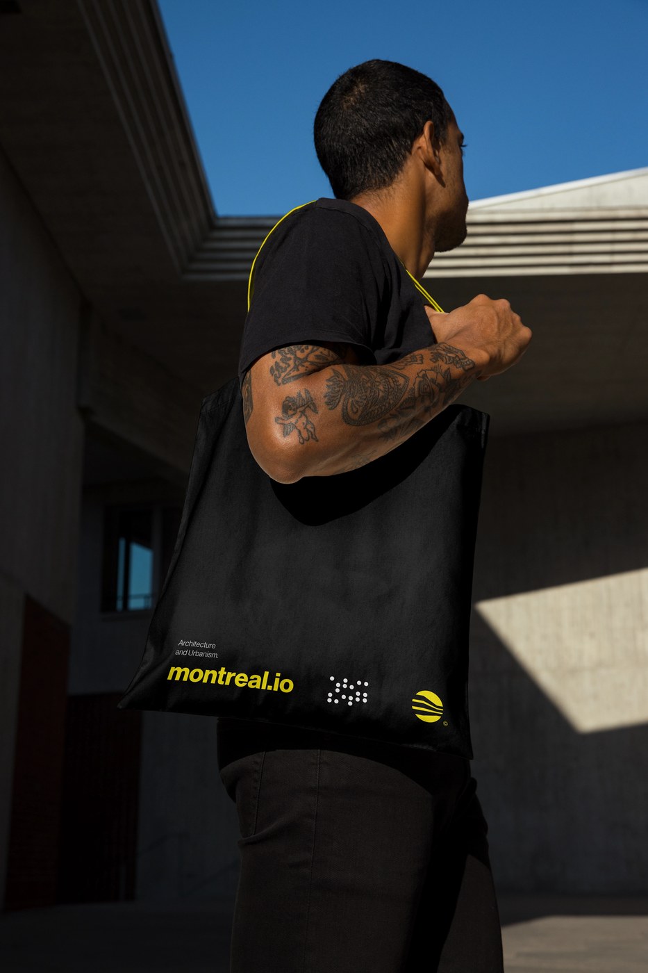 Black cotton canvas tote bag with yellow handles in Montreal Architecture brand identity