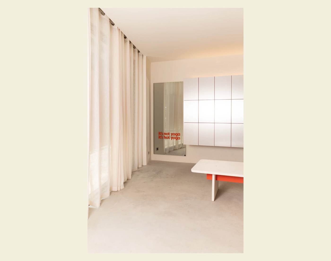 studio interior with linen curtains and environmental typographic mirror slogan