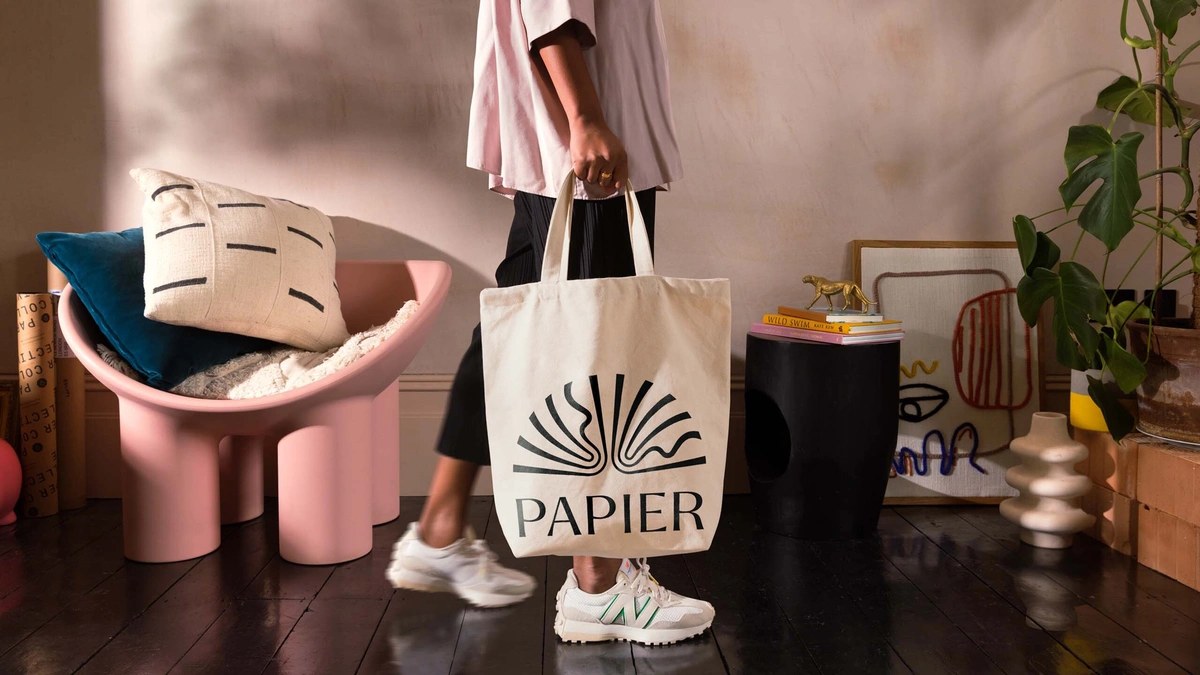 Screenprinted cotton tote bag showing the Papier sunburst logo and wordmark