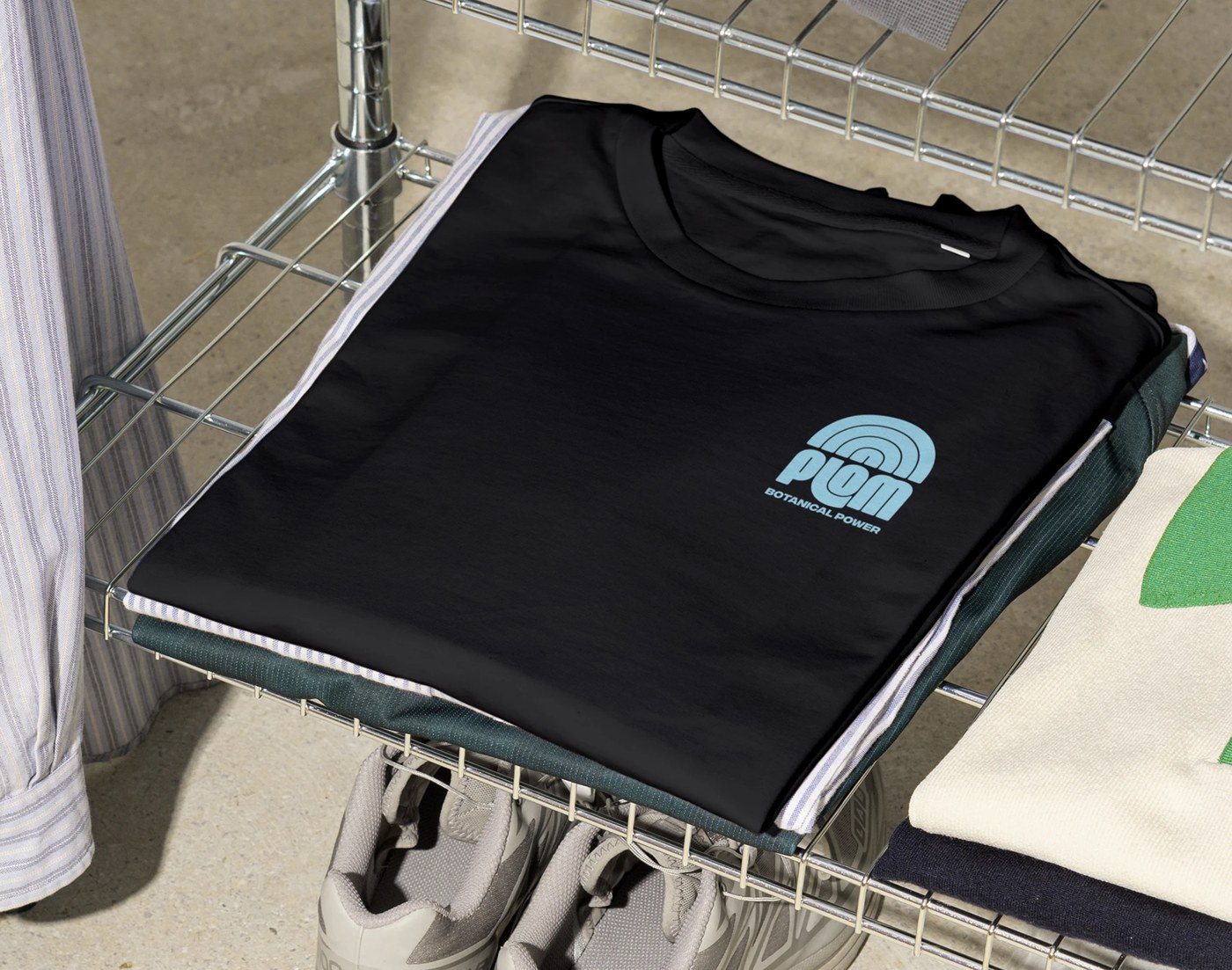 Plom folded training activewear shirt with emblem print — brand identity by Brand Brothers