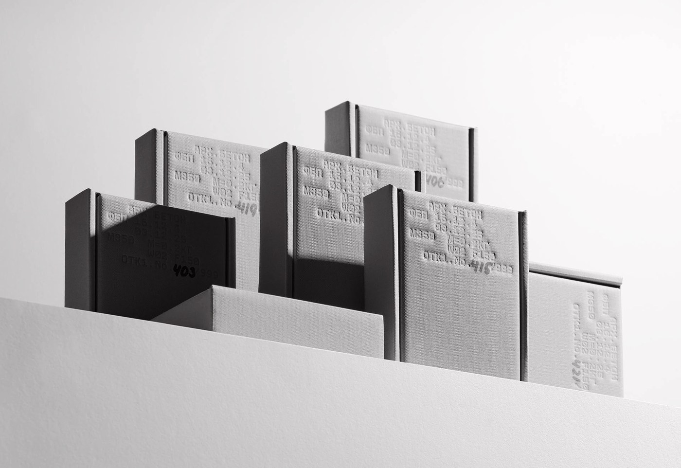 Rigid concrete grey book boxes showcasing industrial packaging design and stamped technical specifications