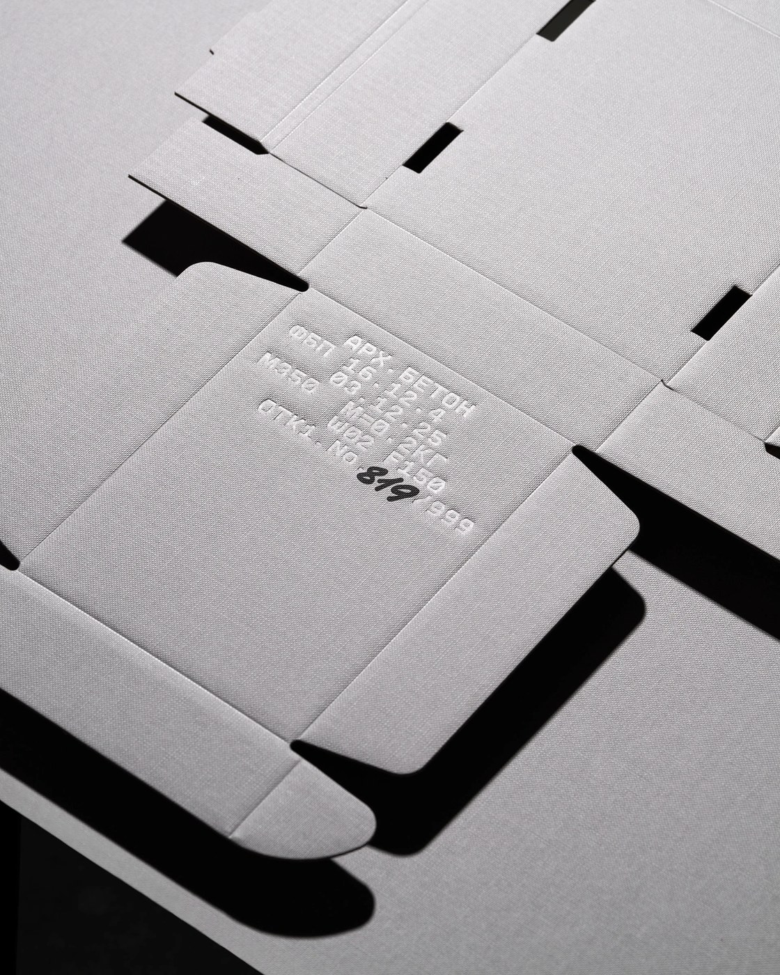 Die-cut unfolded box net and hot foil stamped typography in industrial packaging design