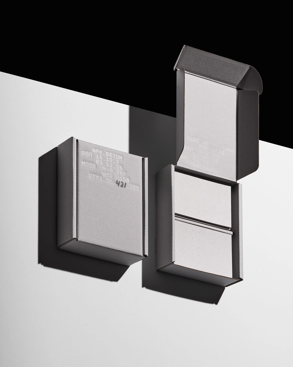 Opened structural gift box with dual interior compartments in architectural packaging design