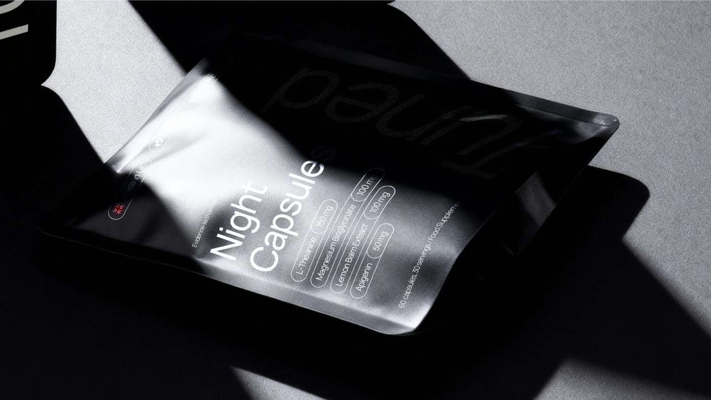 Macro detail of Tuned matte black foil pouch with spot gloss varnish on vertical logotype