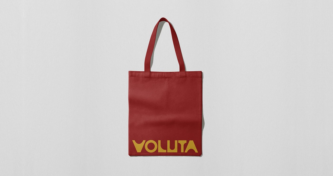Voluta heavy canvas tote bag silkscreened with yellow logotype on deep red textile