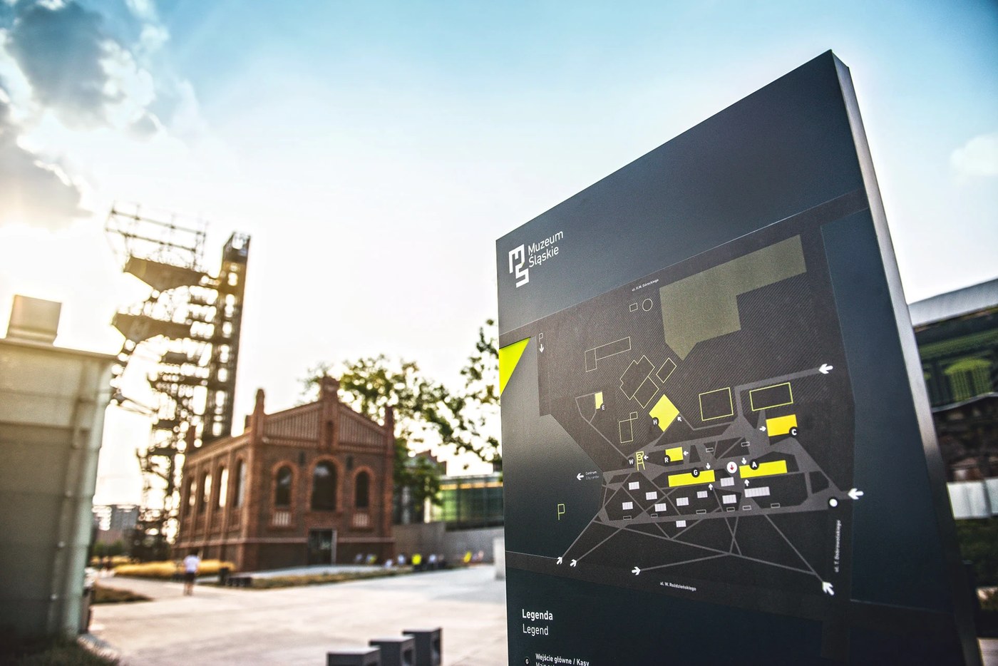 Architectural site orientation map totem with yellow building highlights in spatial design for the Silesian Museum grounds