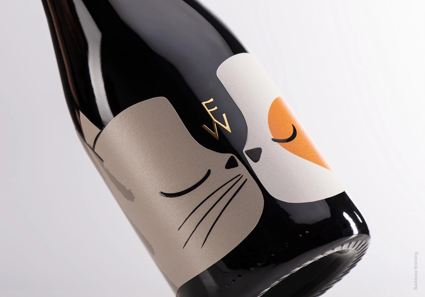 Dark bottle texture and gold monogram in packaging design by Backbone Branding