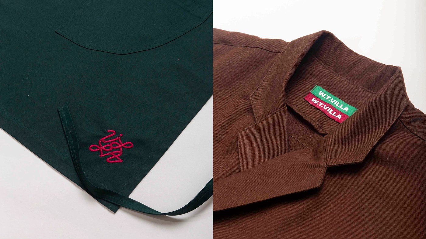Workwear utility apron and jacket showing embroidered knot logo and woven collar tags