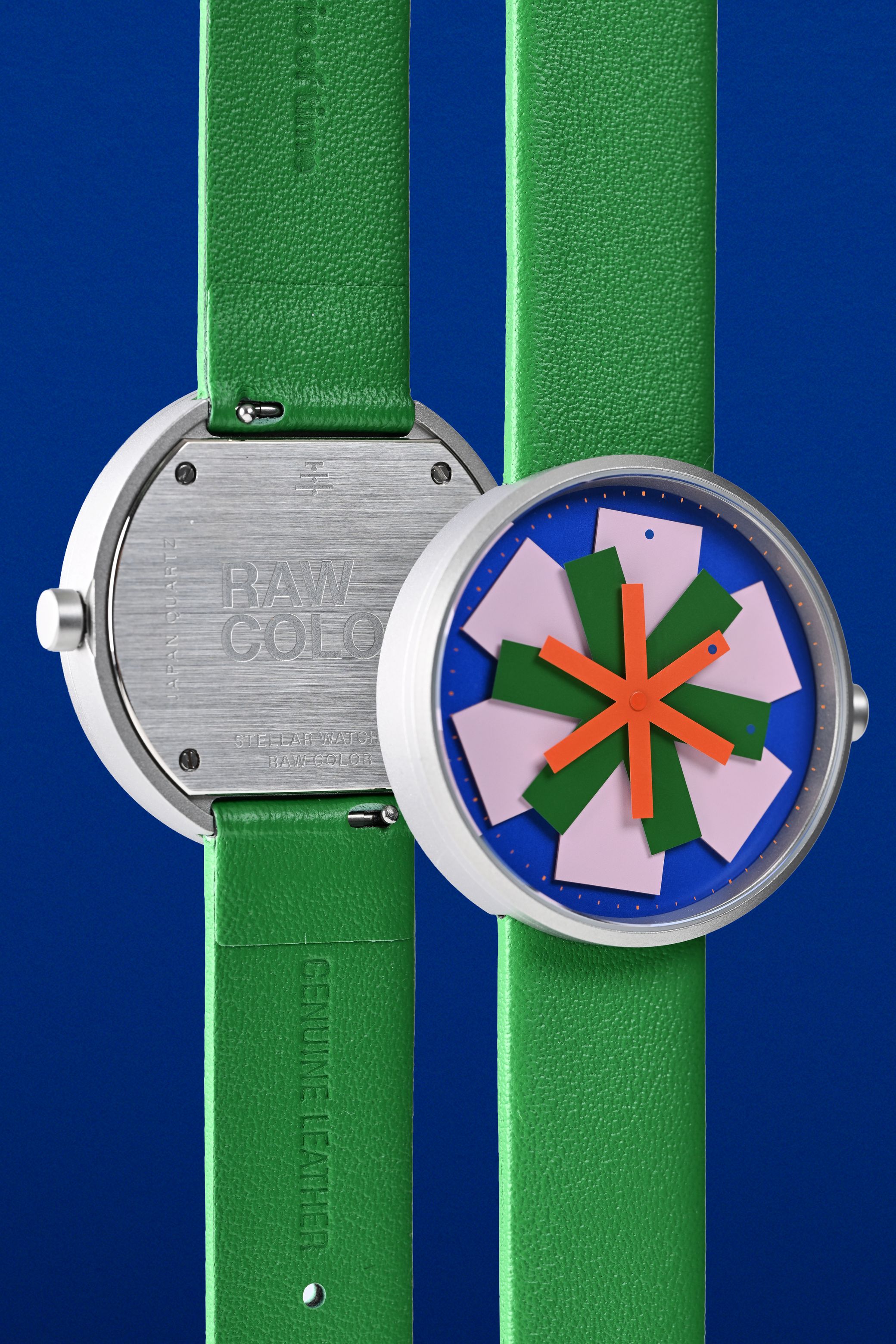 Detailed macro photo showing the overlapping colorful hands of the stellar watch dial design