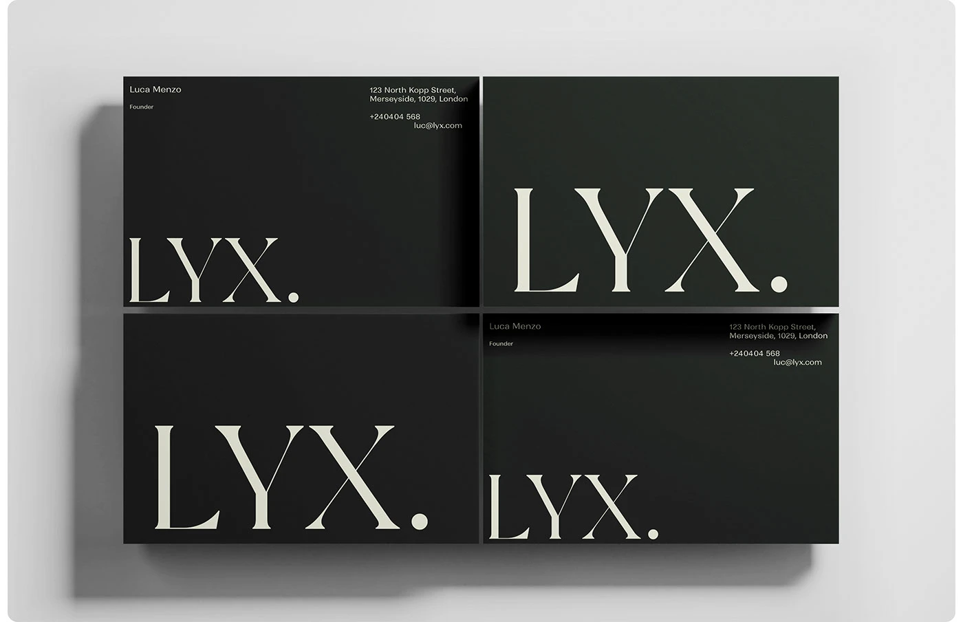 LYX branding black business cards and serif wordmark flat-lay