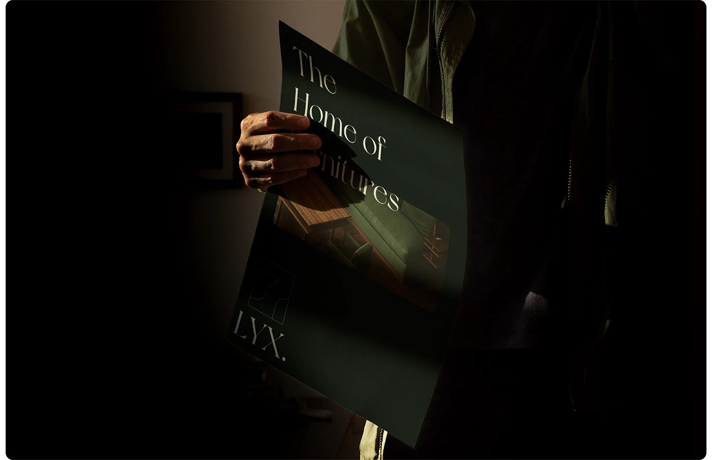 LYX branding printed editorial catalog held in dramatic light