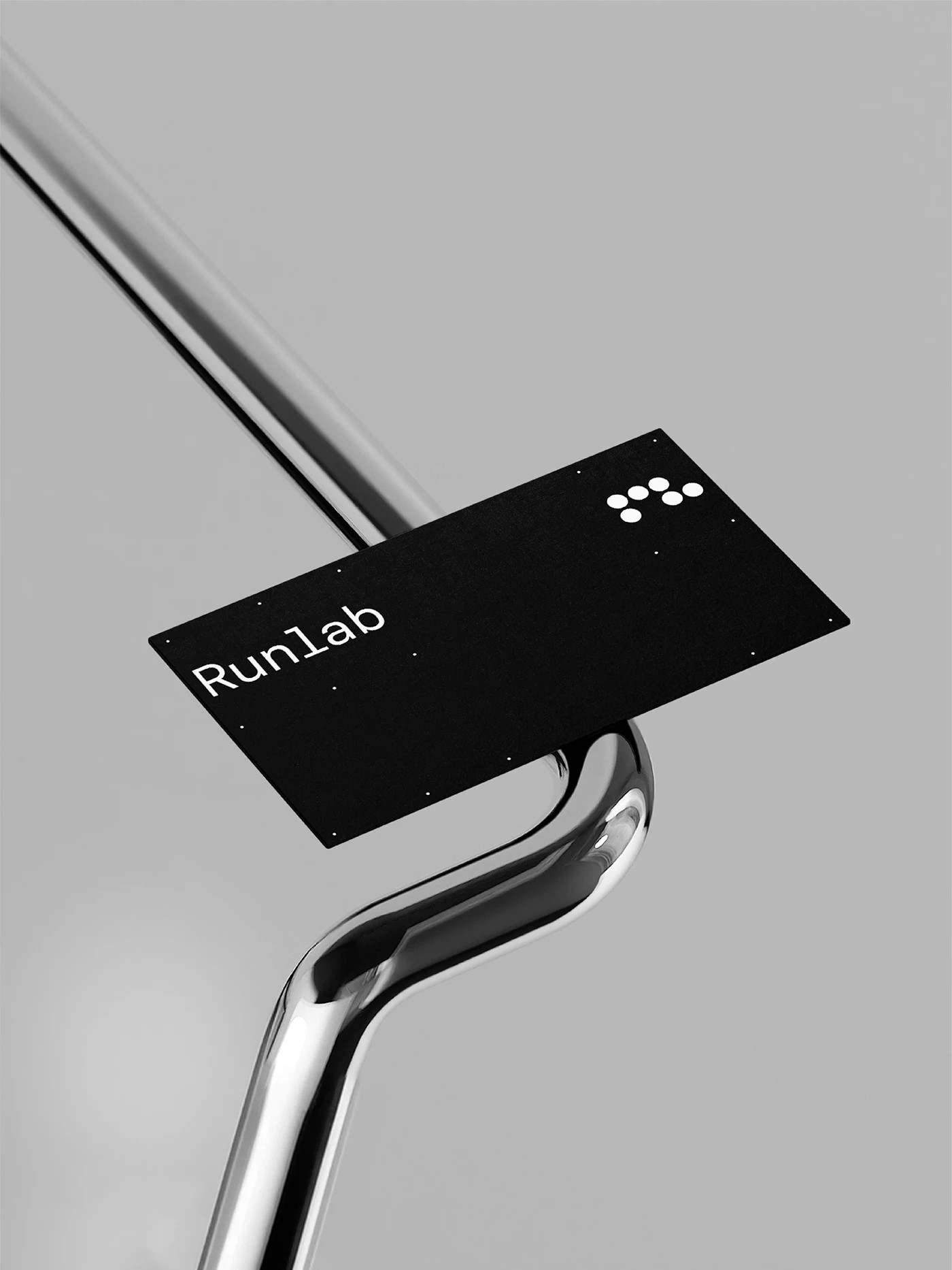 Runlab branding minimal black card on polished chrome tubular hardware