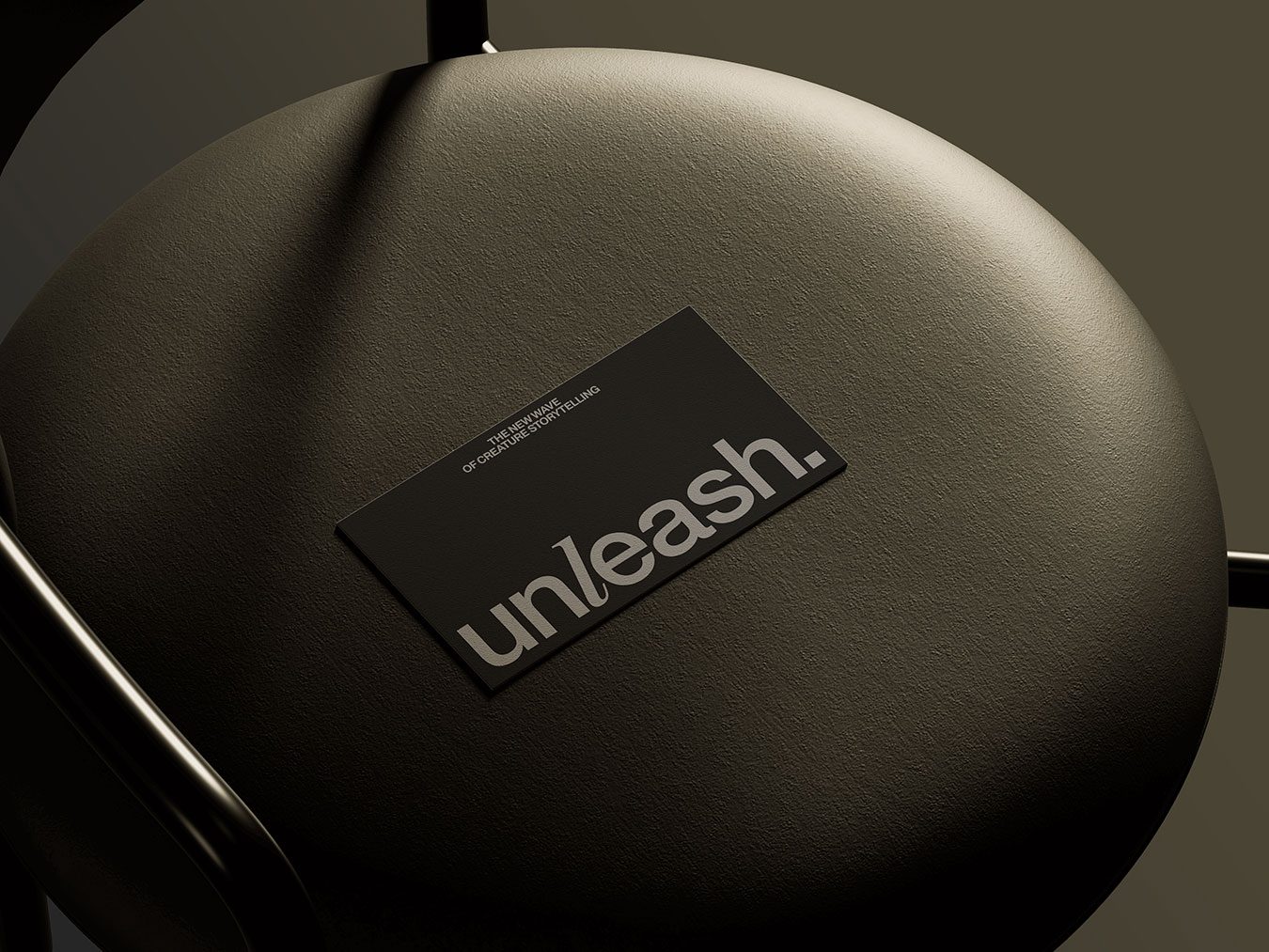 Unleash pet storytelling branding black foil-stamped business card on leather cushion by Stud Creative House